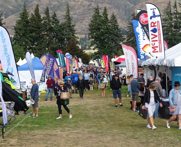 The first of the thousands of Wanaka A&P Show goers wander down one of the trade lanes after the...