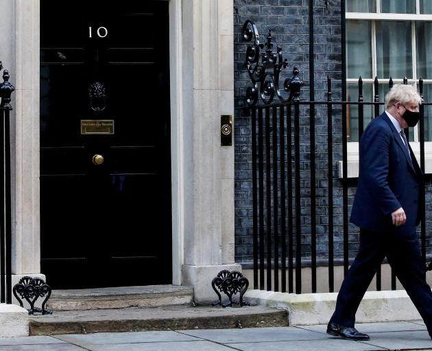 British Prime Minister Boris Johnson walks outside Downing Street in London, but his future is in...