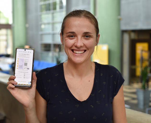 University of Otago master of botany student Aimee Pritchard, of Dunedin, holds up her vaccine...