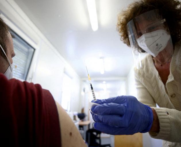 A man gets a Pfizer jab in Vienna.  Roughly 72% of Austria's population is fully vaccinated...