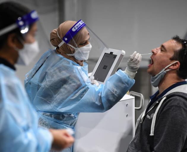 A man undergoes a Covid-19 test at a pre-departure area at Sydney International Airport on Sunday...