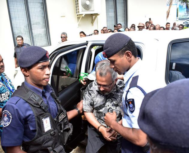 Isoof being taken into custody last September Photo: Fiji Times / REINAL CHAND