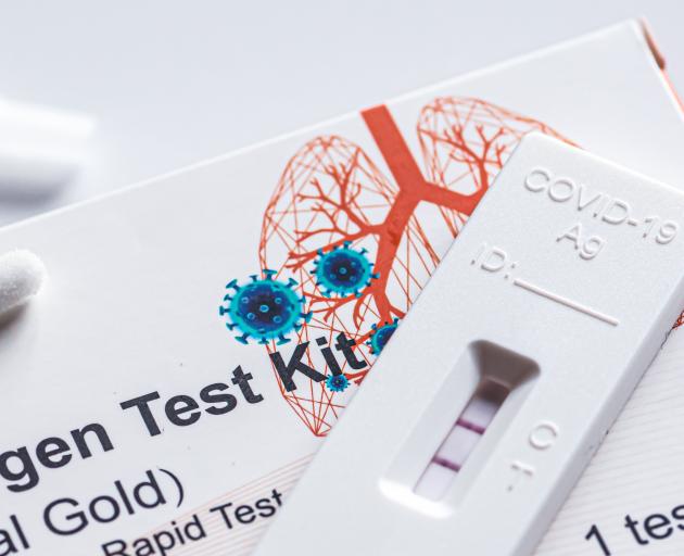 A Covid-19 rapid antigen test kit for self-testing shows a positive result. PHOTO: GETTY IMAGES