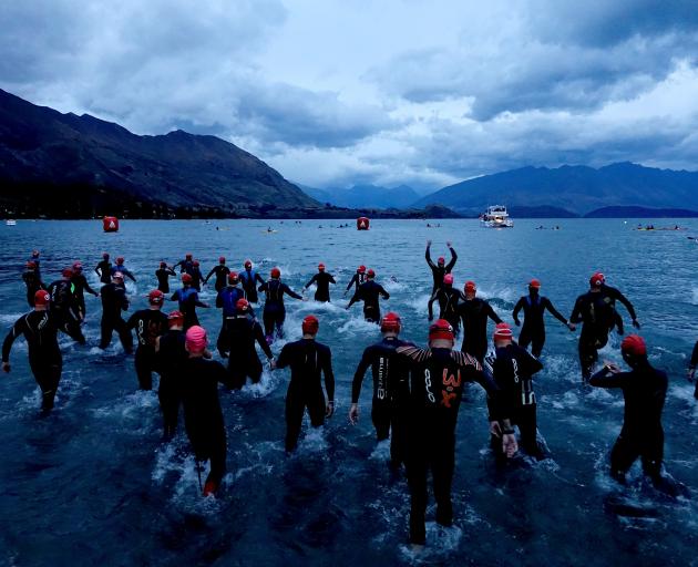 Competitors enter the lake for the start of  Challenge Wanaka on Saturday. Photos: Getty Images