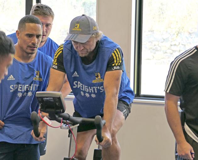 Highlanders coach Tony Brown takes part in a team fitness session under the watchful eye of All...