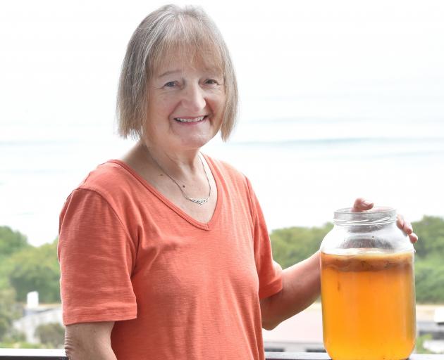 Brighton resident Maureen Marshall and a jar of kombucha with a scoby floating on the top. PHOTO:...