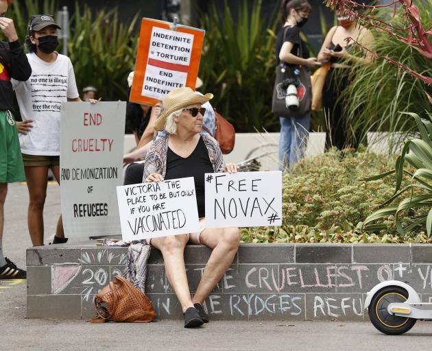 A tennis fan holds a sign outside the Park Hotel in Carlton on January 06, 2022 in Melbourne....