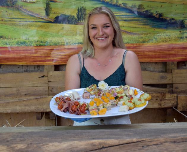 University of Otago student Demi Lawrence, of Dunedin, serves finger food at the annual Tikana...