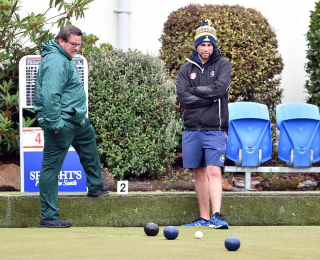 Oliver Mason (front) and rival skip Regan Larkin watch as the bowls roll in during the Dunedin...