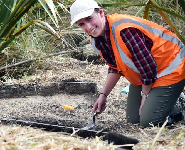 University of Otago archaeology masters student Claire Thorrold (25) looks for remnants of a 500...
