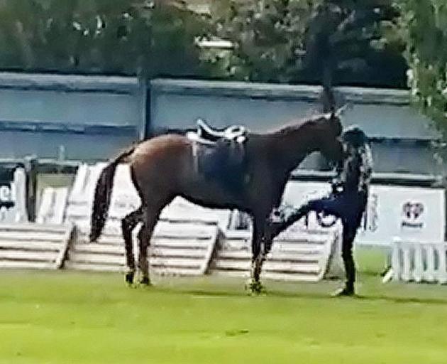 Stills from video footage appearing to show a rider repeatedly kicking and hitting her horse at...