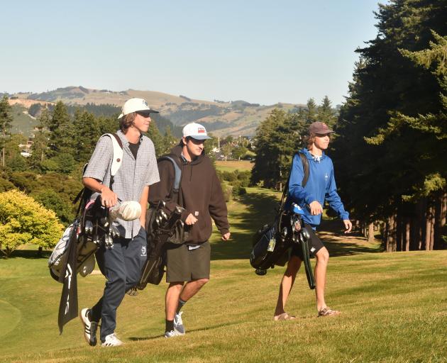 Student golfers (from left) Hudson James-Everton, Will Holmes and Sam James-Everton enjoy a round...