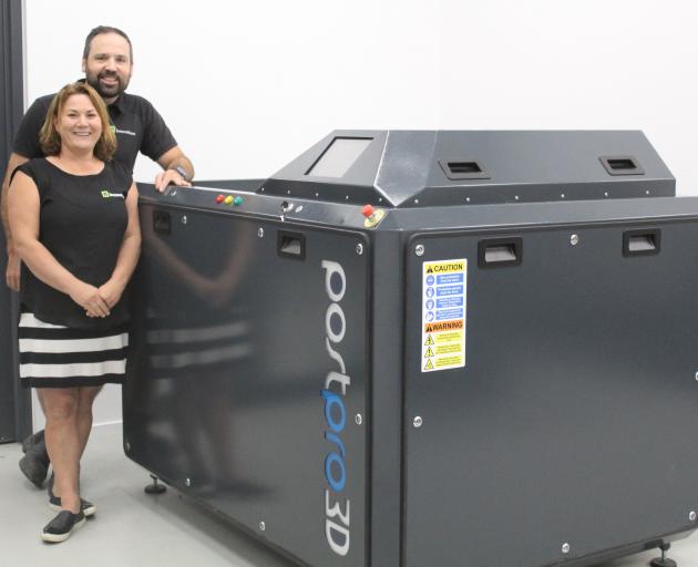 Fi Innovations owners Gareth and Melissa Dykes display their newest 3-D printer at their factory...
