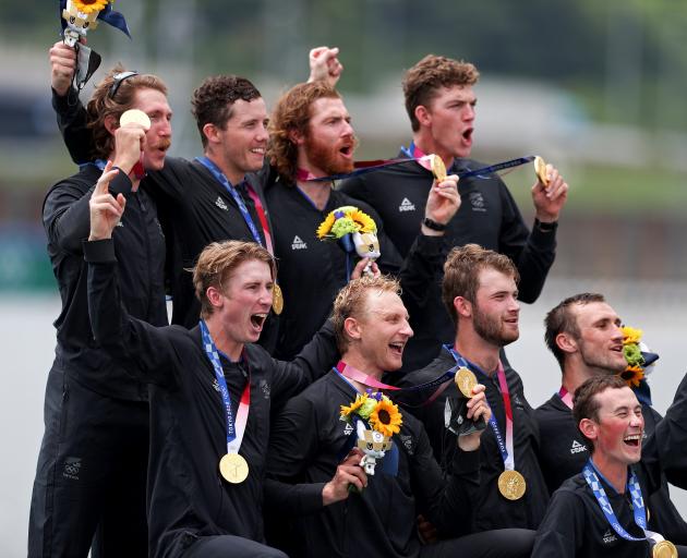 Members of the gold medal-winning New Zealand rowing eight pose with their medals at last year’s...