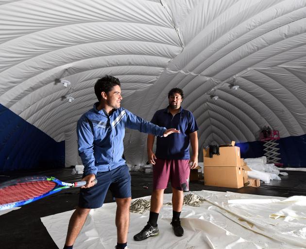 Otago Boys’ High School tennis coach Jaden Grinter (left) tests the potential of the new dome...