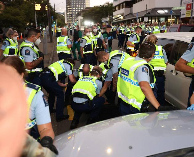 A white car was driven into the crowd as police armed with riot gear move in on the protest this...