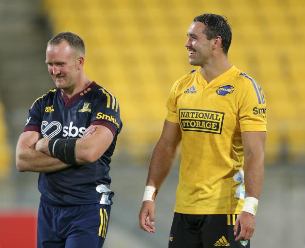 Gareth Evans of the Highlanders (L) and Devin Flanders of the Hurricanes chat after the round...