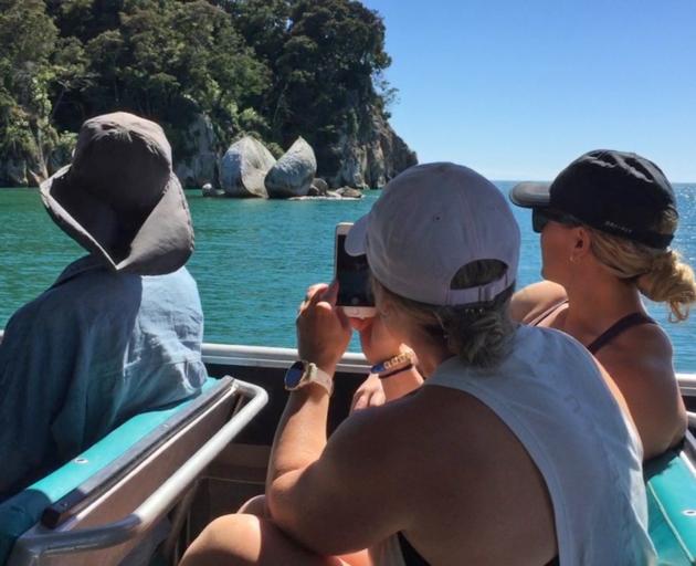 Visitors admire the scenery from aboard the  catamaran Adelle II.  PHOTO: RUDY ADRIAN  