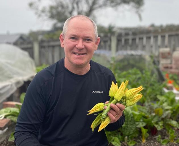 Neil Robinson shows his baby zucchini with flowers still attached. PHOTO: ROBINSON