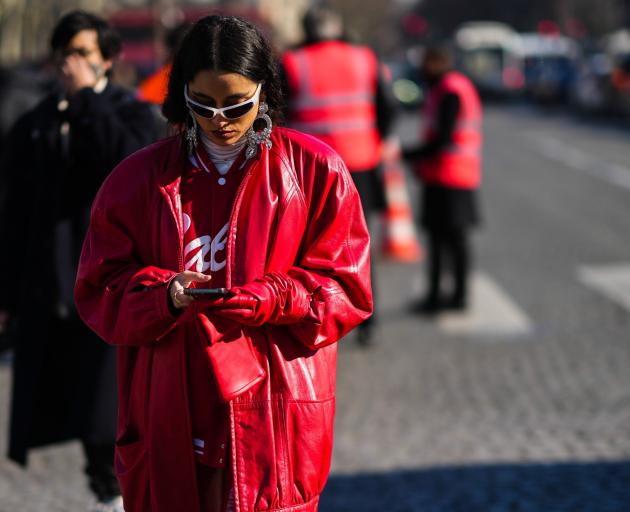 A guest at Chanel’s Paris fashion show embraces bold colour and silhouette with an oversized...