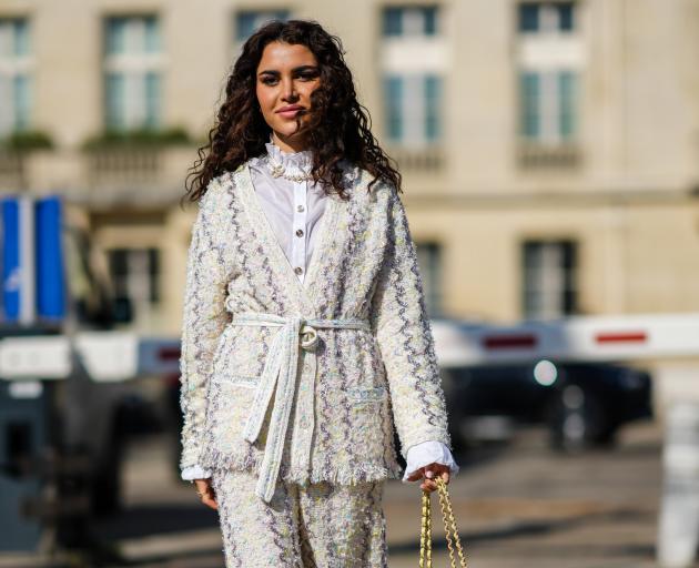 Luxurious texture magnifies the mundane in this glamorous embroidered cream and purple jacket and...