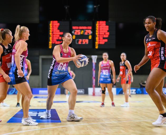 Southern Steel goal attack Saviour Tui looks to pass as Charlotte Elley, of the Tactix, and...
