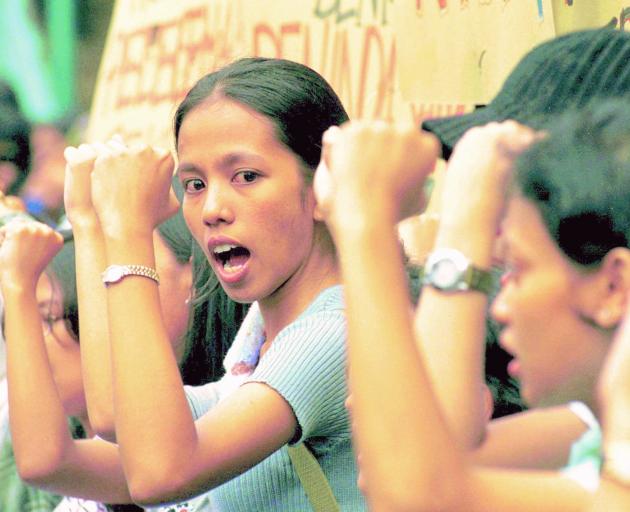 A group of Indonesian female students protest outside the United Nations office to mark the...