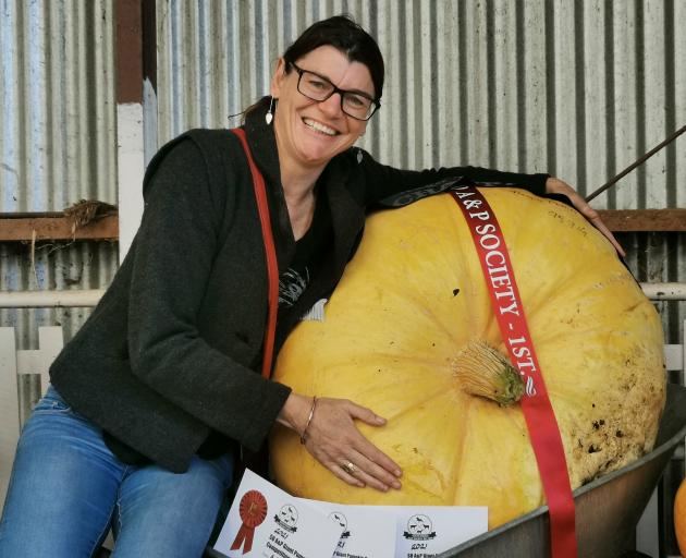 Donna Pettitt hugs her nearly 96kg entry which won the South Otago A&P Show Giant Pumpkin...