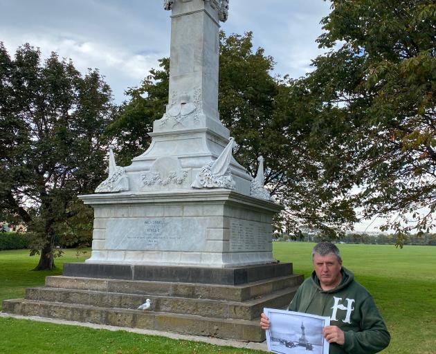 Otago Military Historical Group chairman Peter Trevathan holds a  historical photo of three World...