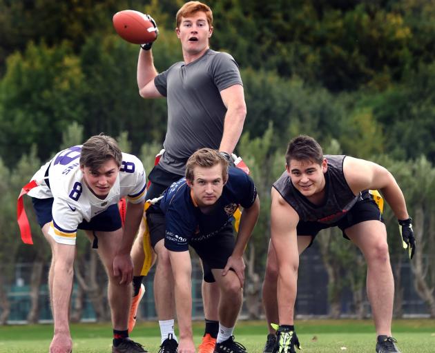 American Football Otago president Tom Rance looks to throw from quarterback as (from left) George...