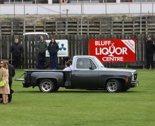 The coffin of Konnor Steele is driven across the Bluff Rugby Club field on the back of a ute....