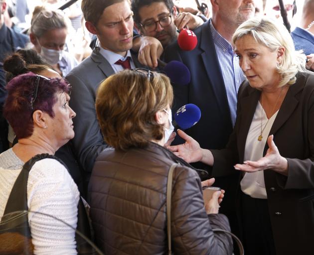 Marine Le Pen speaks with voters at a market in Pertuis, southern France. Photo: Getty Images
