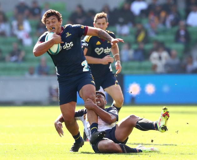 Thomas Umaga-Jensen is snagged during another hard-fought loss for the Highlanders. Photo: Getty...