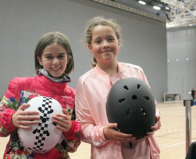 Invercargill girls Mila Morfett (left) and Charlotte Oliver watch roller derby for the first time...
