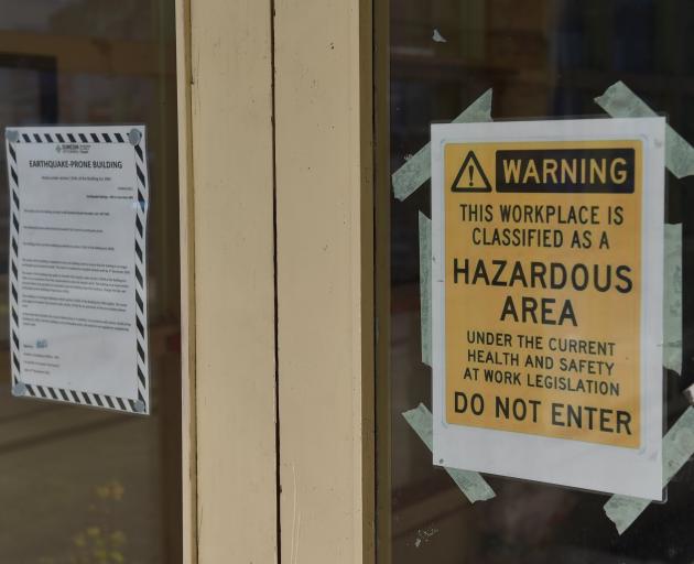 A sign on the window indicates the building is hazardous and says not to enter. PHOTO: GREGOR...