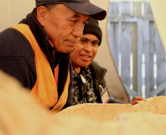 Papa Mata Taurarii (left) and Papa Toni Tekie check on a vaka they are building in Caversham....