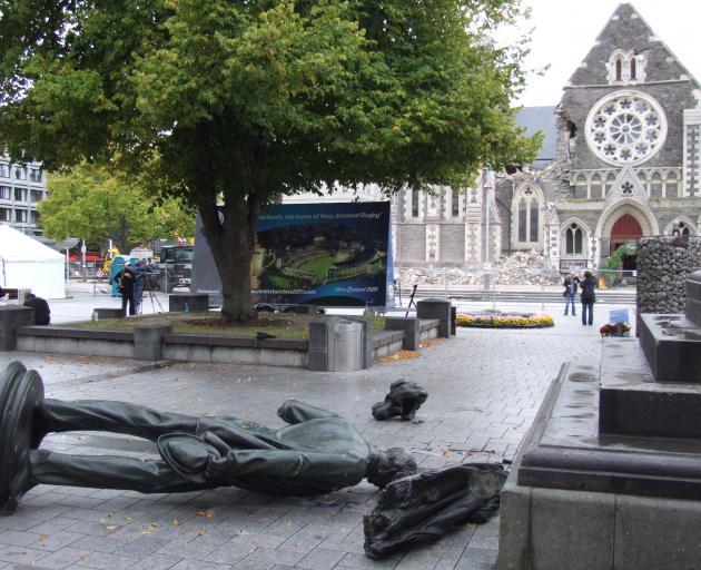 A statue of Christchurch founder John Robert Godley, smashed from its pedestal by the force of...