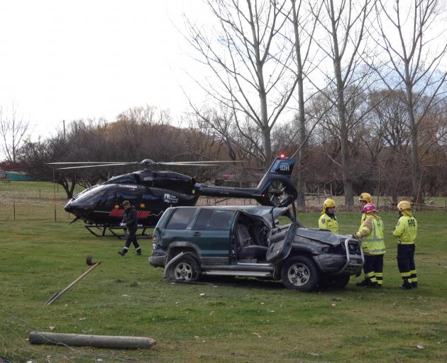 Emergency services work at the scene of a two-vehicle crash near Alexandra that left a woman...