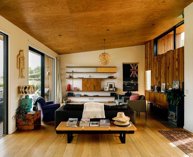 Redwood is used on the home’s exterior and the eastern wall of the living area (seen at the right...