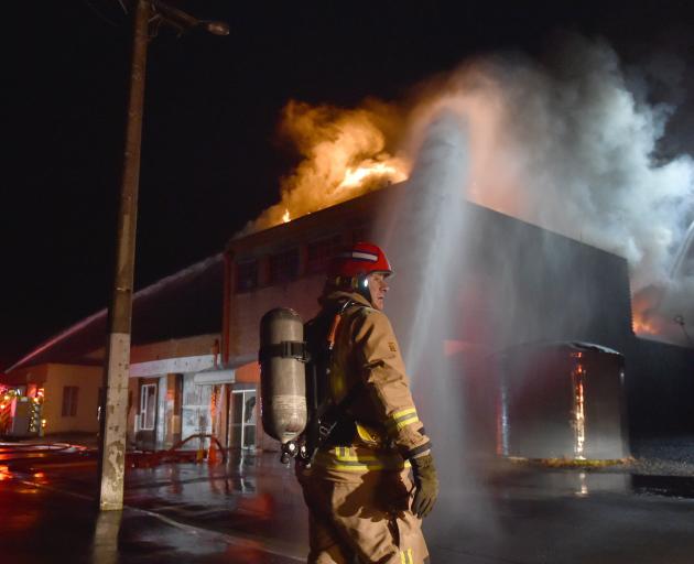 Firefighters tackle a large fire at the former Wolfenden and Russell building in South Dunedin in...