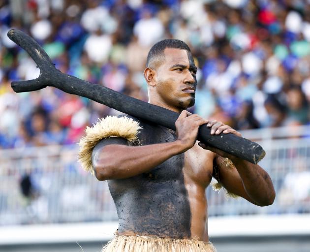 a Fijian cultural performer in action.