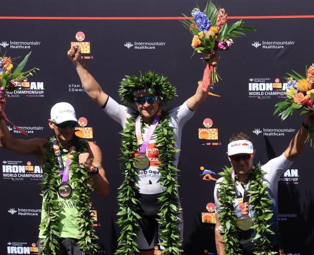 (L-R) Second place finisher Lionel Sanders of Canada, first place winner Kristian Blummenfelt of Norway and third place finisher Braden Currie of New Zealand celebrate on the podium after the 2021 IRONMAN World Championships. Photo: Getty Images