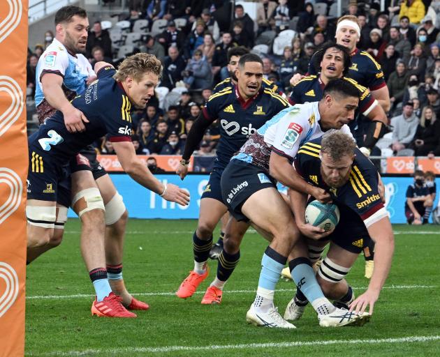 Josh Dickson, playing his 50th game for the Highlanders, crashes over for a try in the tackle of...