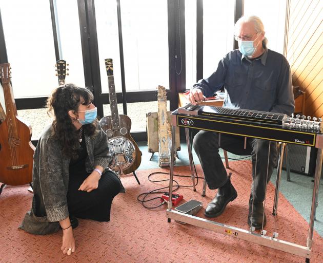 Dr Hyram Ballard demonstrates a pedal steel guitar to Caitlyn Lester at the Nook and Cranny Music...