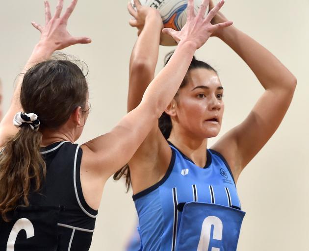 St Hilda’s centre Gemma Rowcroft assesses her options while defended by Southern centre Grace...