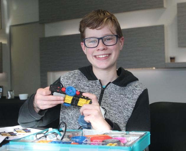 Mitchell Powell (12) was happy to build a robot during the workshop.