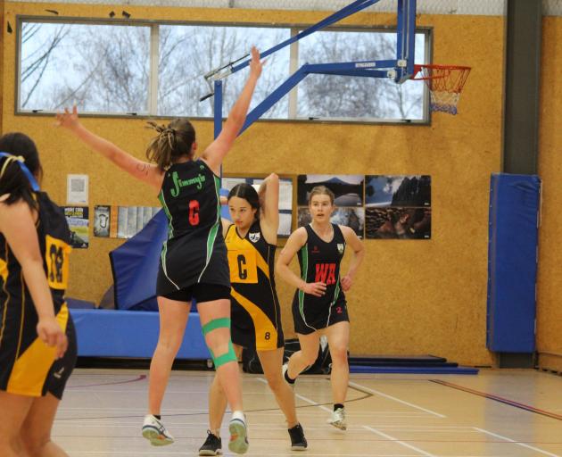 Catlins centre Amelia Morrison looks to pass around Roxburgh counterpart Maddison Excell in a...