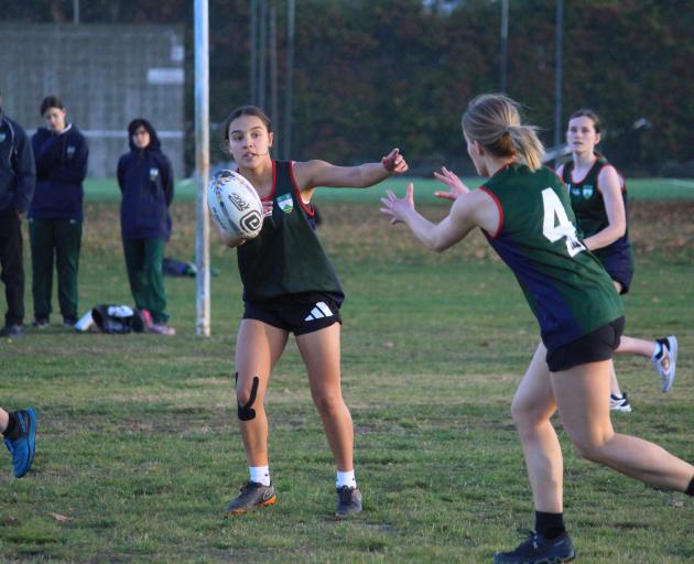 Shahni White (left) passes to Roxburgh touch team-mate Sarah Gunn at the area schools tournament.