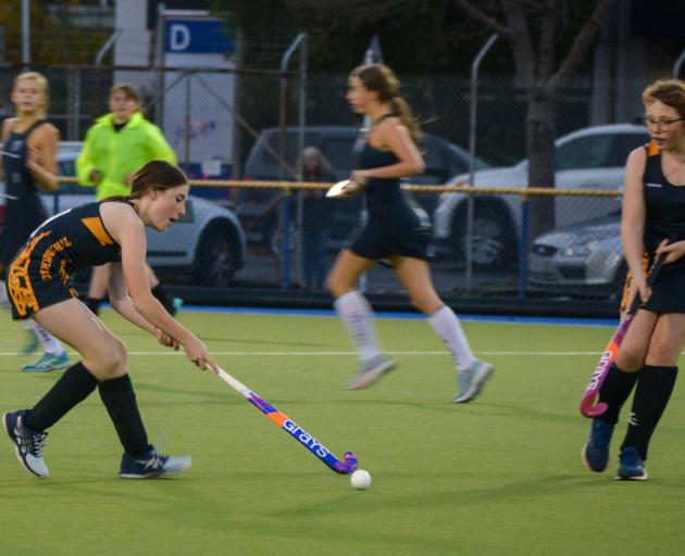 Tokomairiro High School hockey players Pippa Greene (left) and Kaitlin Burgess work on a move.