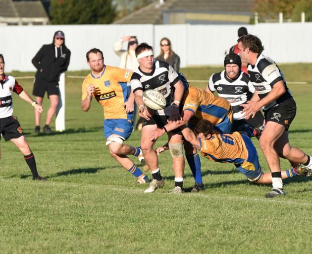 Liam Robinson off loads to Ryan Koning. Photo: Karen Casey